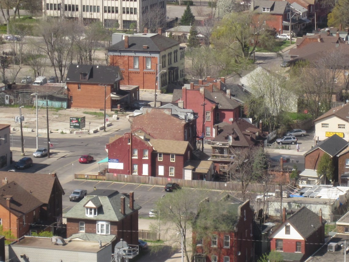 backyards of surviving homes filled in with extensions and parking spaces